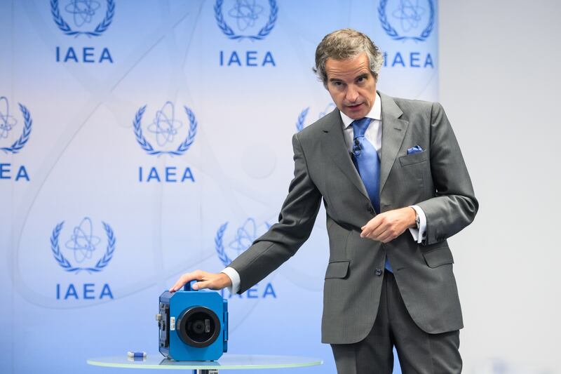 Rafael Grossi, director general of the International Atomic Energy Agency, with the kind of camera used by the IAEA to monitor nuclear work in Iran. EPA