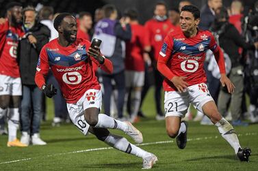 Lille's French midfielder Jonathan Ikone (L) and Lille's French midfielder Benjamin Andre celebrate after winning the French L1 football match between Angers SCO and Lille OSC at The Raymond-Kopa Stadium in Angers, north-western France on May 23, 2021. / AFP / LOIC VENANCE