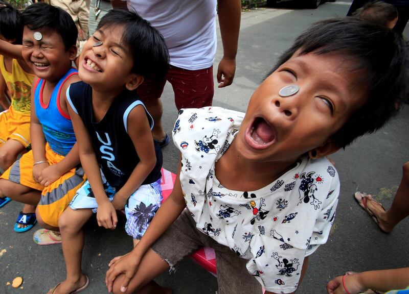 Boys use their faces and tongues, to move a coin from their foreheads into their mouths, at a town fiesta parlour game, in celebration of the patron saint Santa Rita de Cascia in Baclaran, Paranaque City, Metro Manila, Philippines. Romeo Ranoco / Reuters