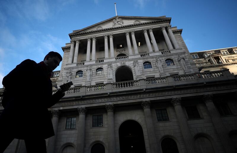 FILE PHOTO: A man walks past the Bank of England in the City of London, Britain, February 7, 2019. REUTERS/Hannah McKay/File Photo