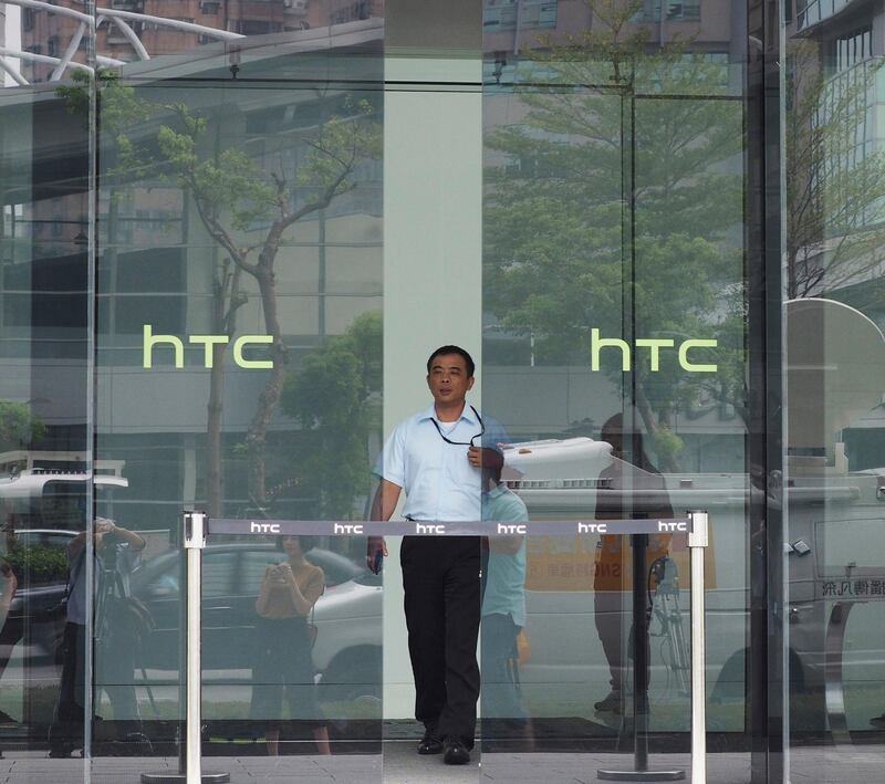 epa06216915 The logo of HTC is shown on the glass door of HTC Corp. headquarters in Hsintien, New Taipei City, Taiwan, 21 September 2017. On 21 September, HTC announced that it is selling its smartphone business to Google and licensing certain interllectual property (IP) rights to Google for 1.1 billion US dollars. According to representatives of HTC, the deal stengthens HTC-Google cooperation and HTC will continue to work on its next flagship smartphone and develop its virtual reality system called 'VIVE'.  EPA/DAVID CHANG