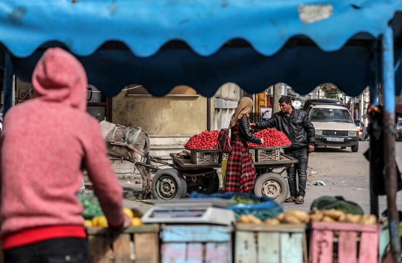 Palestinian vendors sell vegetables and strawberries in the streets of Gaza City. EPA