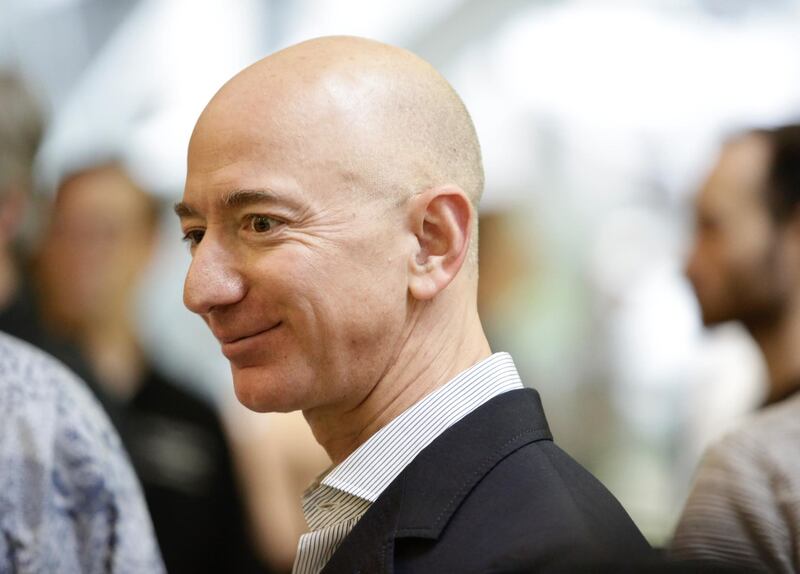 (FILES) In this file photo taken on January 29, 2018 Chief Executive Officer of Amazon, Jeff Bezos, tours the facility at the grand opening of the Amazon Spheres, in Seattle, Washington. 
Jeff Bezos is officially the richest person on the planet thanks to the success of Amazon -- but his bold vision extends to space and even time itself.With Amazon's share price up nearly 60 percent during the past year, the personal wealth of the company's 54-year-old founder has doubled to more than $110 billion.
 / AFP PHOTO / JASON REDMOND