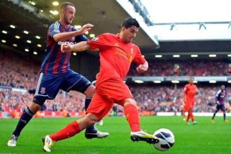 Luis Suarez, second right, the Liverpool striker, endured another frustrating afternoon at Anfield. Paul Eliis / AFP
