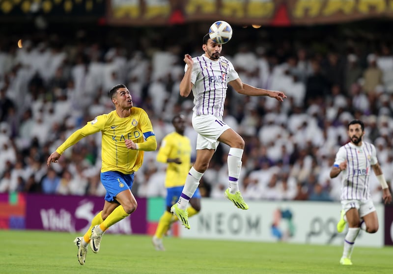  Al Ain's Khalid Al Hashemi is challenged by Al Nassr's Cristiano Ronaldo.