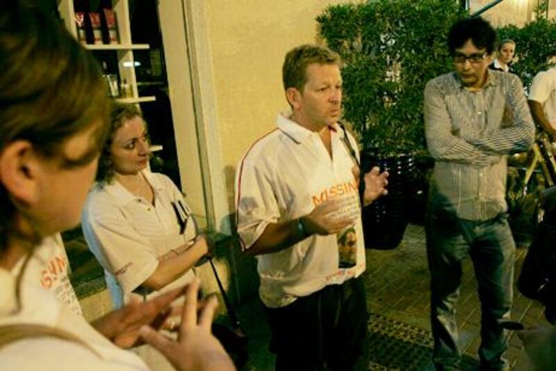 Dubai, United Arab Emirates, June 8 2012,The Regent Hotel Bur Dubai, Missing Sailor- (centre right white shirt and  wearing shorts) "Neil" the uncle of the missing Sailor Timmy Maccoll  talks with the media in  front of the Rock Bottom Club  which is part of the Regent Hotel in Bur Dubai.  Mike Young / The National
