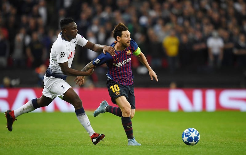 Tottenham Hotspur's Victor Wanyama vies for the ball with Barcelona's Lionel Messi. EPA