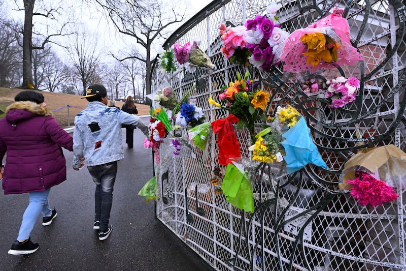 Fans enter Graceland for the memorial service for Lisa Marie Presley. AP
