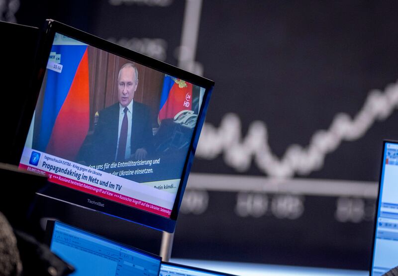 Russian President Vladimir Putin appears on a television screen at the stock market in Frankfurt, Germany. Russia's military offensive in Ukraine has accelerated inflation fears and rattled global markets. AP
