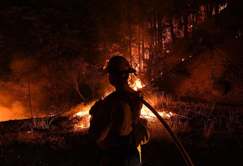 Firefighter Shawn Lee from the Lake Forest unit, tries to contain flames from the Carr fire as it spreads towards the town of Douglas City near Redding, California.  AFP PHOTO / Mark RALSTON