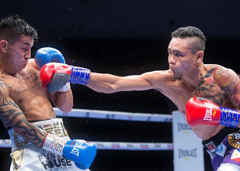 Dubai, United Arab Emirates - Donnie Nietes of the Philippines (right) hitting Pablo Carillo of Colombia at the Rotunda, Ceasar's Palace, Bluewaters Island, Dubai.  Leslie Pable for The National