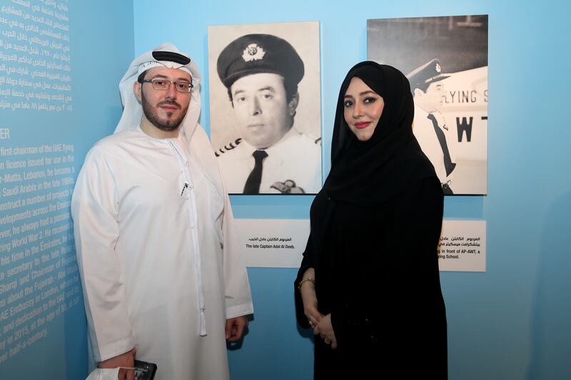 Nora and Fadi Adel Al Deeb next to a picture of their late father at the exhibition. Photo: Sharjah Museums Authority.