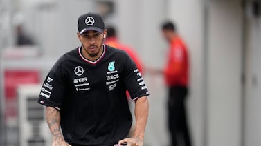 Mercedes driver Lewis Hamilton rides a scooter after the second practice session at the Japanese Grand Prix. EPA