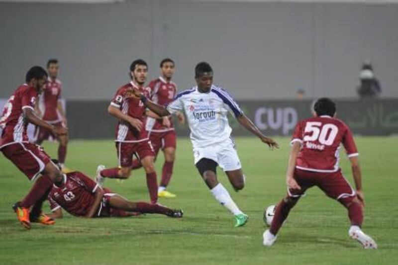 Asamoah Gyan, centre, scored twice during Al Ain’s 4-1 win over Al Wahda on Friday night.