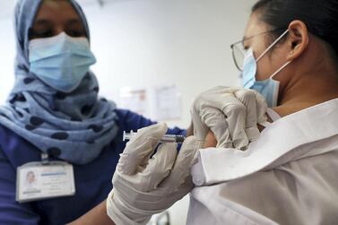 A nurse gives a patient a flu shot at Prime Hospital in Dubai. Masks and flu vaccines are contributing to record low numbers of influenza this year. Pawan Singh / The National