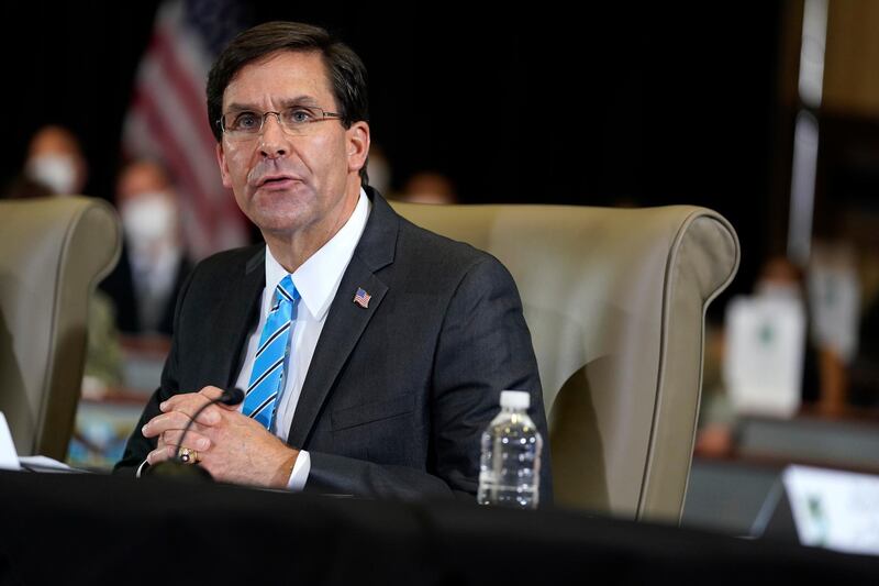 FILE - In this July 10, 2020, file photo Defense Secretary Mark Esper speaks during a briefing on counternarcotics operations at U.S. Southern Command in Doral, Fla. Defense leaders are weighing a new policy that would bar the display of the Confederate flag at department facilities without actually mentioning its name, several U.S. officials said Thursday, July 16. Esper discussed the new plan with senior leaders this week. (AP Photo/Evan Vucci, File)