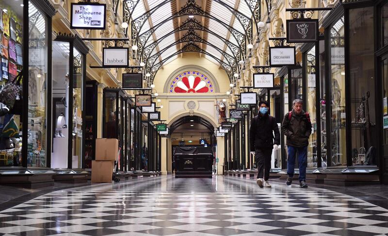 People walk through a shopping arcade in Melbourne, Australia, as the city re-enters a lockdown after a fresh outbreak of the Covid-19 coronavirus. AFP