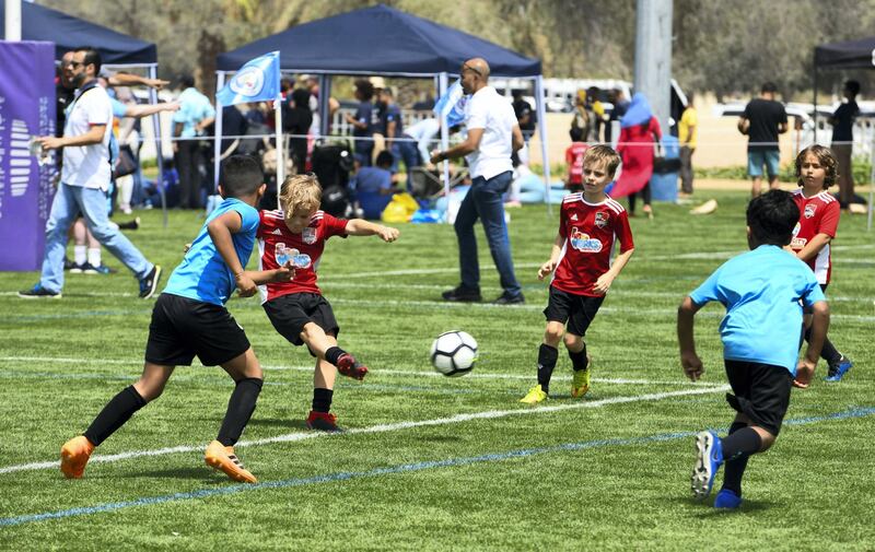 Abu Dhabi, United Arab Emirates - Techers Bahrain (blue) vs. Go Sports (red) under 8 age group on Abu Dhabi World Cup Day 1 at Zayed Sports City. Khushnum Bhandari for The National
