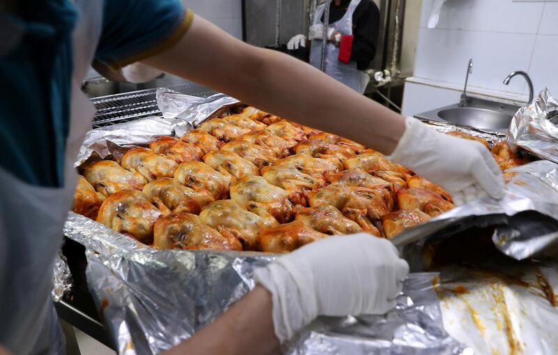 DUBAI, UNITED ARAB EMIRATES , May 01 – 2020 :- Staff of Al Nadeg restaurant in Deira Dubai preparing the food to deliver at the labour camp in Al Muhaisnah area in Dubai. This is a part of Mohammed Bin Rashid Al Maktoum 10 Million Meals Global Initiative. Volunteers from Beit Al Khair Society will distribute the food packets in the labour camps. Today they are delivering 1000 food packets from Al Nadeg restaurant. Total 12000 food packets will be deliver in different labour camps in Dubai. (Pawan Singh / The National) For News/Online/Instagram. Story by Anam