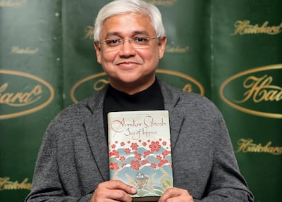 Indian author Amitav Ghosh poses for pictures with his book "Sea of Poppies" at a photocall in London, on October 14, 2008. Ghosh is one of six authors shortlisted for the 2008 Booker Prize to be announced later Tuesday in London. AFP PHOTO/Leon Neal (Photo by LEON NEAL / AFP)
