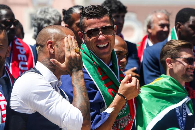 Portugal’s forward Cristiano Ronaldo (R) and Portugal’s forward Ricardo Quaresma laugh as they celebrate their victory at Belem Palace on July 11, 2016 after their Euro 2016 final football win over France yesterday. The Portuguese football team led by Cristiano Ronaldo returned home to a heroes’ welcome today after their upset 1-0 win triumph over France in the Euro 2016 final. AFP / NUNO FOX