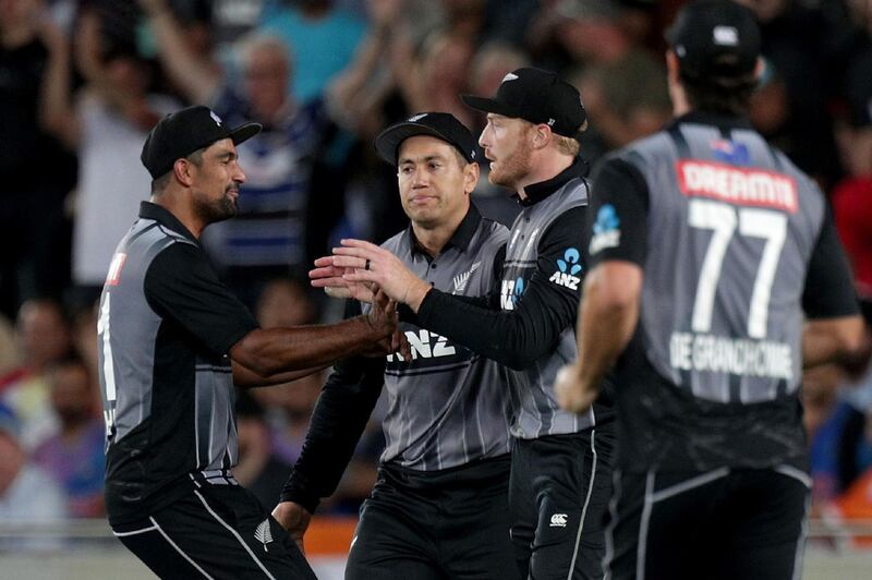 New Zealand players celebrate the wicket of India captain Virat Kohli during the first T20 in Auckland. AFP