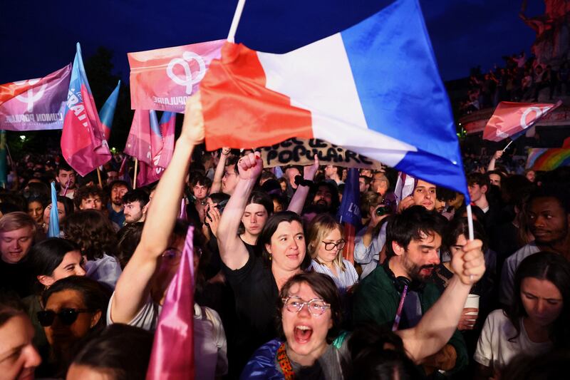 Demonstrators hold French flags and Union Populaire Française flags in support of the New Popular Front alliance as they gather to protest against the far-right National Rally in Paris. Reuters