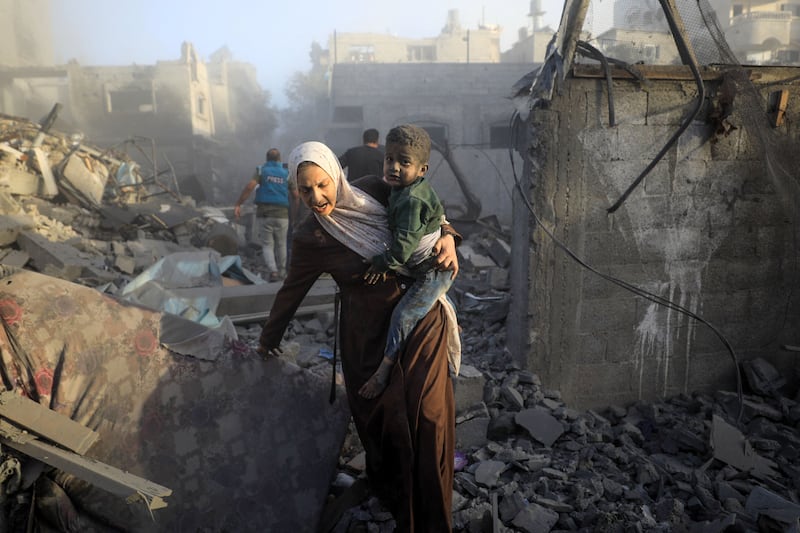 People flee after Israeli air strikes on the Maghazi refugee camp. AFP