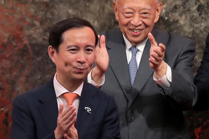 Chairman and CEO of Alibaba Group Daniel Zhang Yong, left, and Vice Chairman of the National Committee of the Chinese People's Political Consultative Conference Tung Chee-hwa attend the Alibaba Group's listing ceremony at the Hong Kong Stock Exchange (HKEX) in Hong Kong, Tuesday, Nov. 26, 2019. (AP Photo/Kin Cheung)