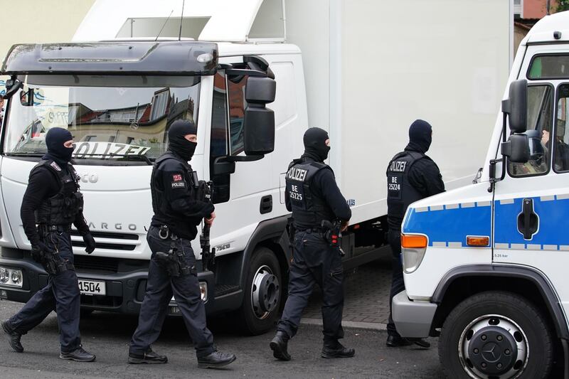 Police officers walk in front of the Al-Irschad association during a raid in Berlin, Germany.  EPA