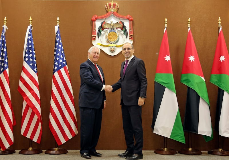 US Secretary of State Rex Tillerson, left, and Jordanian Foreign Minister Ayman Safadi, shake hands in Amman, Jordan, Wednesday Feb. 14, 2018. The Trump administration is set to boost aid to Jordan by more than $1 billion over the next five years, in spite of President Donald Trump's repeated threats to punish countries that don't agree with U.S. policy in the Middle East. (AP Photo/Raad Adayleh)