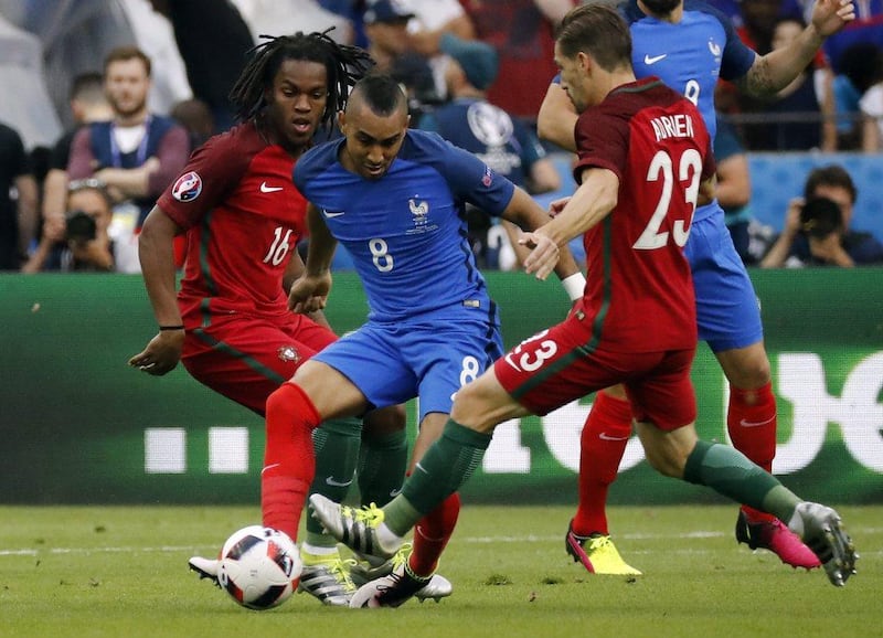 Dimitri Payet of France (C) in action against Renato Sanches of Portugal (L) and Adrien Silva of Portugal during the Uefa Euro 2016 Final match between Portugal and France at Stade de France in Saint-Denis, France, 10 July 2016. Etienne Laurent / EPA
