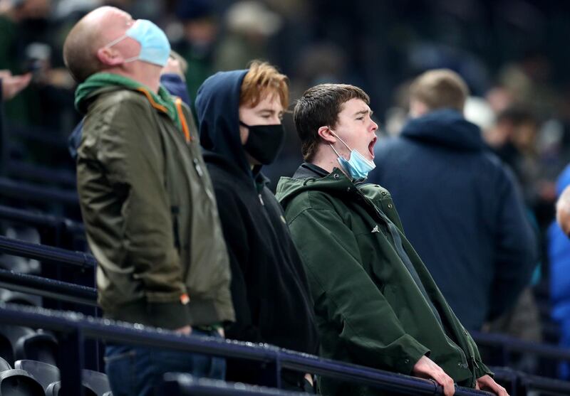 Fans cheer from the stands as they watch the players warm up at the Tottenham Hotspur Stadium. PA