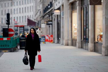 A pedestrian walks along a near-deserted street in central London on Black Friday. AFP