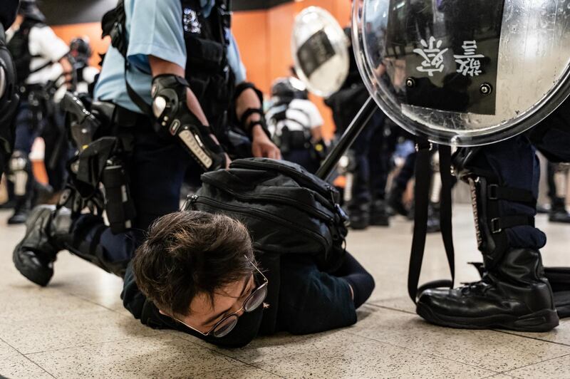 HONG KONG, CHINA - SEPTEMBER 5: A protester is detained by police at Po Lam Station on September 5, 2019 in Hong Kong, China. Pro-democracy protesters have continued demonstrations across Hong Kong since 9 June against a controversial bill which allows extraditions to mainland China, as the ongoing protests, many ending up in violent clashes with the police, have surpassed the Umbrella Movement from five years ago and become the biggest political crisis since Britain handed its onetime colony back to China in 1997. Hong Kong's embattled leader Carrie Lam announced the formal withdrawal of the controversial extradition bill on Wednesday, meeting one of protesters' five demands after 13 weeks of demonstrations. (Photo by Anthony Kwan/Getty Images) *** BESTPIX ***
