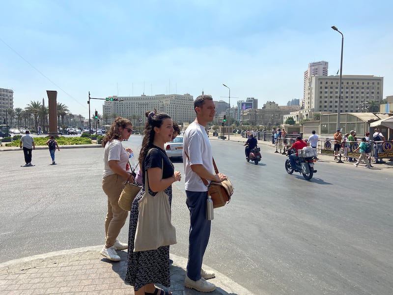 A family of French tourists wait for the right moment to cross the street to the Egyptian Museum.