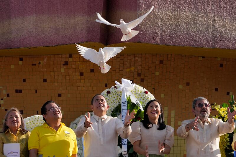 Quezon City Mayor Joy Belmonte, second from right, releases white pigeons to mark the 37th anniversary of the "People Power" revolution in Quezon city, Philippines. AP Photo