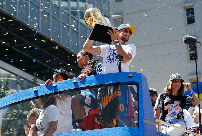 Golden State Warriors guard Stephen Curry holds up the Larry O'Brien NBA Championship Trophy. John G. Mabanglo / EPA