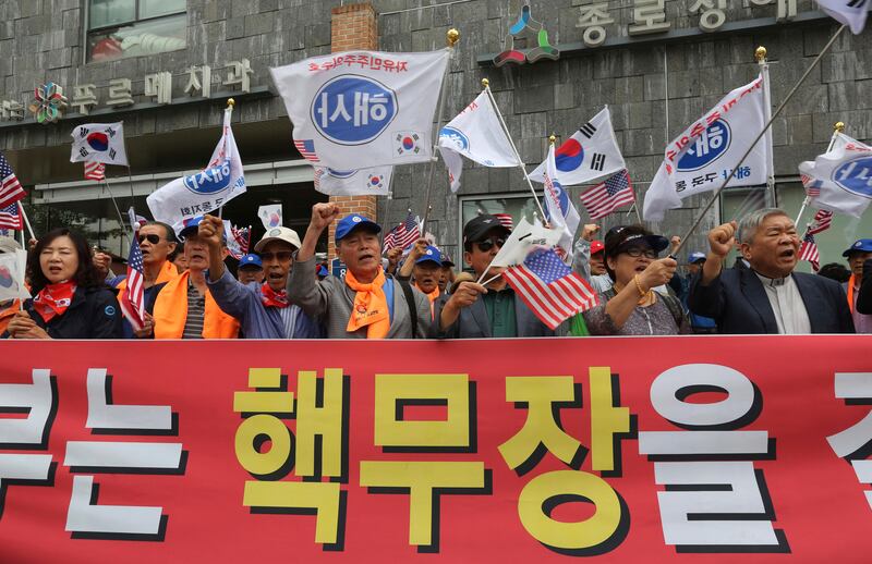 South Korean protesters rally to demand the deployment of nuclear weapons in South Korea near the presidential Blue House in Seoul, South Korea, Tuesday, Sept. 5, 2017. South Korean warships have conducted live-fire exercises at sea. The drills Tuesday mark the second-straight day of military swagger from a nation still rattled by the North's biggest-ever nuclear test. The signs read "The government should to deploy nuclear weapons." (AP Photo/Ahn Young-joon)