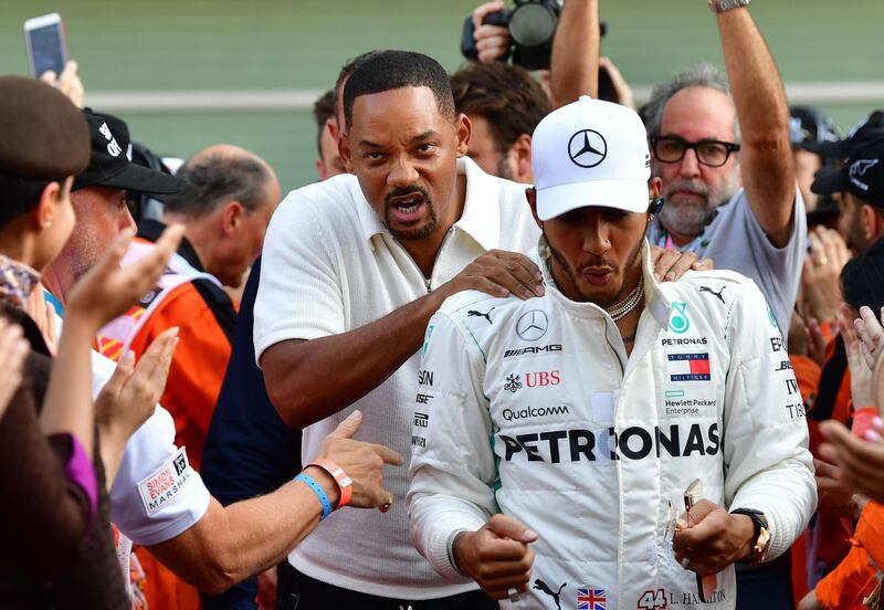 Mercedes' British driver Lewis Hamilton (R) and US actor Will Smith. AFP