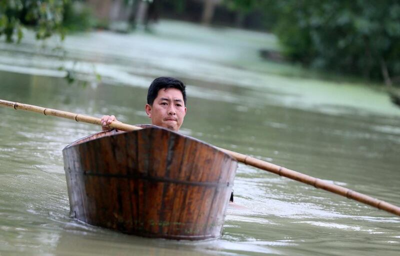 A man rows a wood basin on a flooded street in Hefei, Anhui province, China. Reuters / Stringer