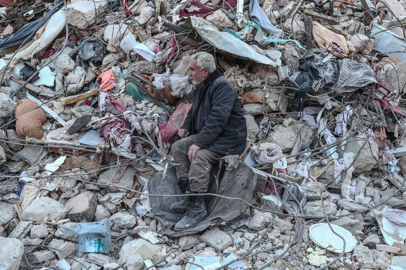 A man looks bewildered at the site of collapsed buildings in Hatay, Turkey. EPA