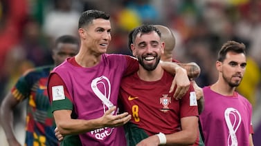 Portugal's Cristiano Ronaldo and Portugal's Bruno Fernandes celebrate their win during the World Cup group H soccer match between Portugal and Uruguay, at the Lusail Stadium in Lusail, Qatar, Tuesday, Nov.  29, 2022.  (AP Photo / Aijaz Rahi)