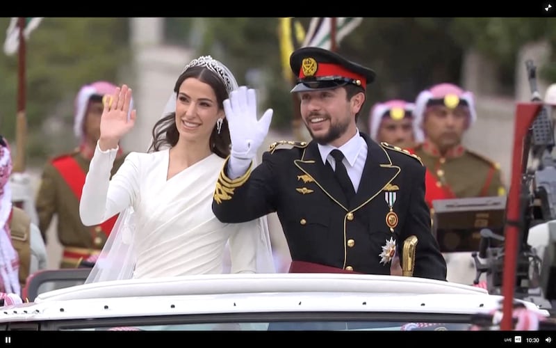 The royal couple wave on their way to their wedding reception. Reuters