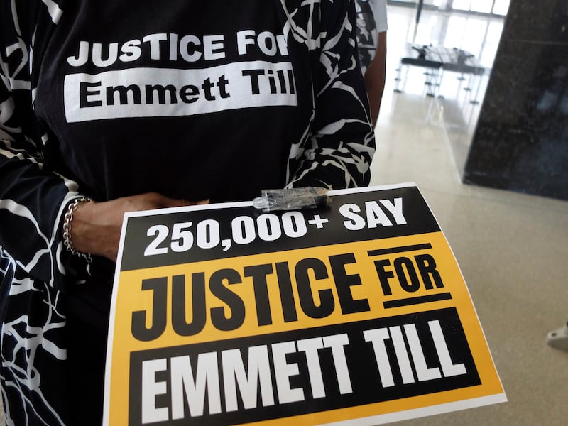 Deborah Watts, a cousin of Emmett Till, holds a poster and the thumb drive. AP