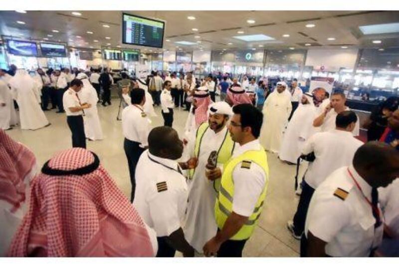 Kuwait Airways employees stopped work at the airport in Kuwait City Monday,  demanding  pay increases.