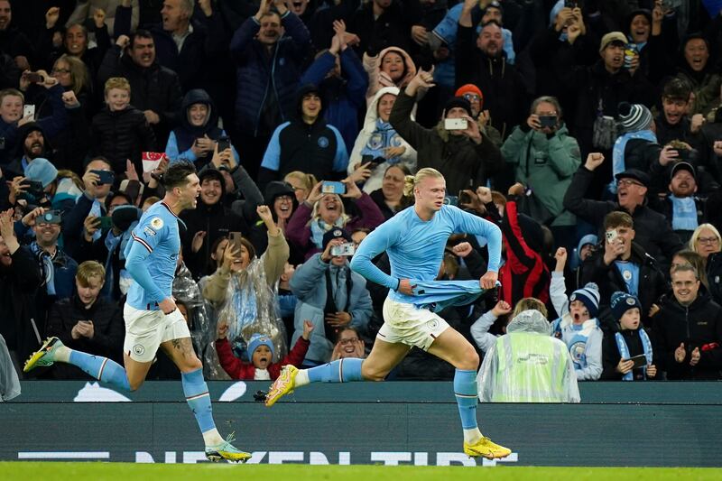 Haaland leads the celebrations with John Stones after netting the late winner. AP