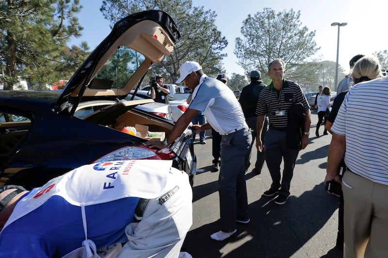 Mandatory Credit: Photo by Gregory Bull/AP/Shutterstock (6104533h)
Tiger Woods Tiger Woods takes off his shoes as he loads his car after withdrawing during the first round of the Farmers Insurance Open golf tournament, in San Diego
Farmers Insurance Open Golf, San Diego, USA
