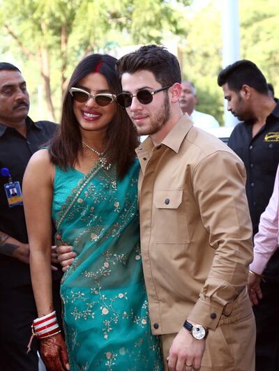 epa07205486 Bollywood actress Priyanka Chopra and Nick Jonas pose for photographs as they leave after their wedding ceremony, in Jodhpur, India, 03 December 2018.  EPA/SUNIL VERMA