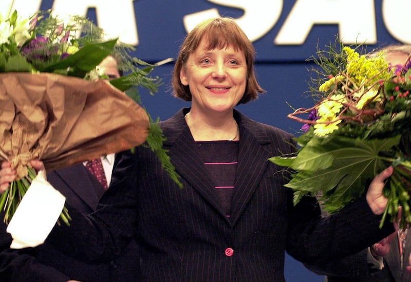 Angela Merkel cheering with flowers after being elected as the new leader of Christian Democratic Union, April 4, 2000. AFP